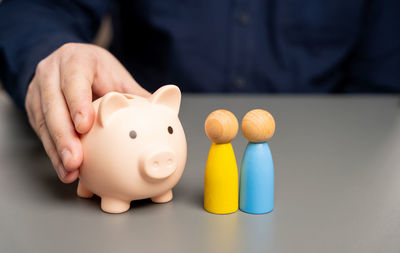 Midsection of man holding piggy bank