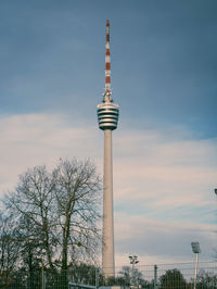 Low angle view of stuttgart tv tower against blue, cloudy sky