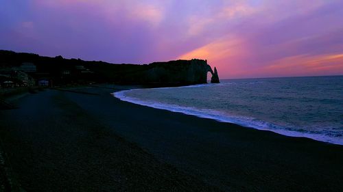 Scenic view of beach against sky during sunset