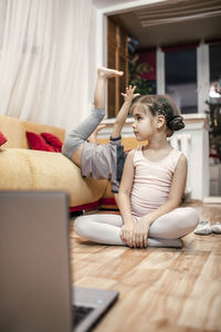 Online hobby, distant training. young ballerina practicing choreography during online ballet class