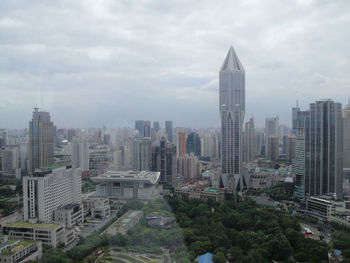 Skyscrapers against cloudy sky