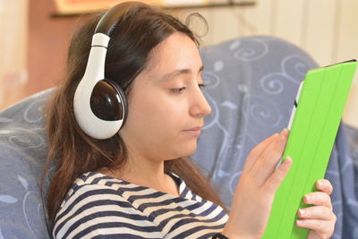 Portrait of young woman holding mobile phone