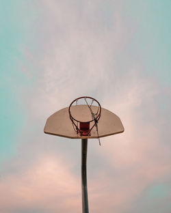 Low angle view of basketball hoop against sky during sunset