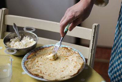 Close-up of man preparing food on table