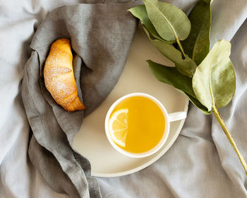 A cup of tee  and croissant, breakfast in bed 