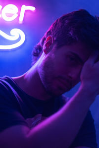 Portrait of young man with neon lights