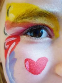 Close-up portrait of woman with heart shape