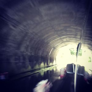 Cars in illuminated tunnel