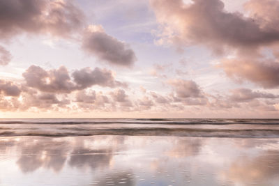 Scenic view of beach against sky during sunset