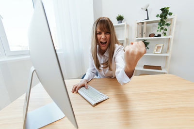 Portrait of young woman working at office