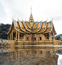 Temple by building against sky