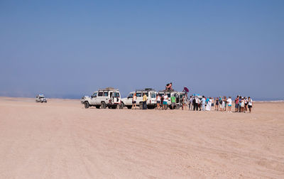 People and cars at desert