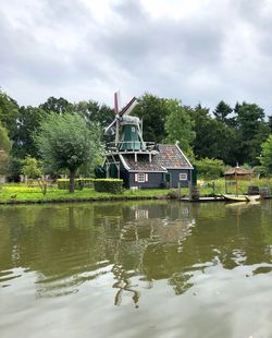 Built structure by lake against sky