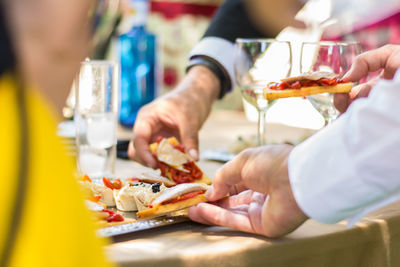 Midsection of people having food in restaurant