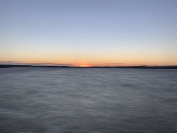 Scenic view of sea against clear sky during sunset