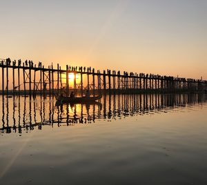 Silhouette pier on sea against sky during sunset