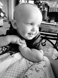 Portrait of cute baby girl sitting on floor