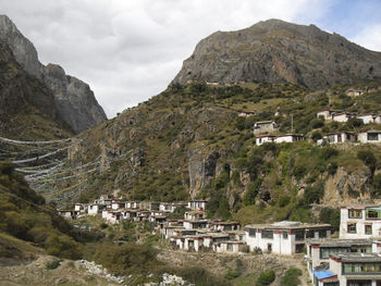 Scenic view of buildings and mountains against sky