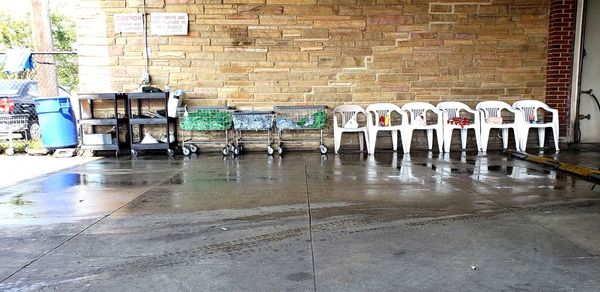Empty chairs against wet wall in building