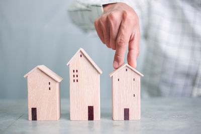 Close-up of hand with toy on house in building