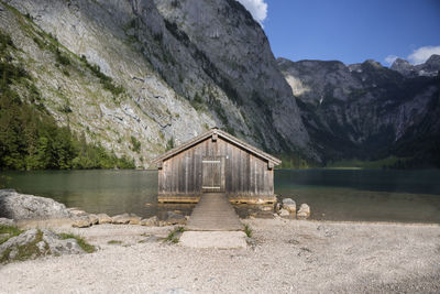 House by lake against mountain