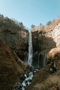 Scenic view of waterfall against sky