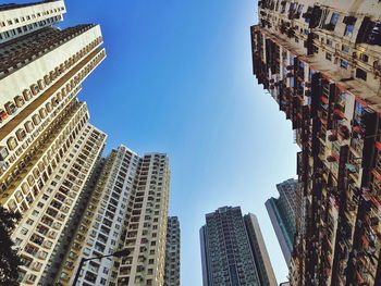 Low angle view of buildings against blue sky