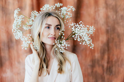 Portrait of beautiful woman looking away wearing flowers