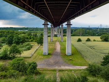 View of bridge and trees against sky