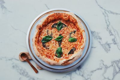 High angle view of pizza served on table