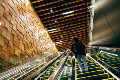 Man standing on escalator