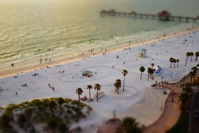 High angle view of people at beach during sunset