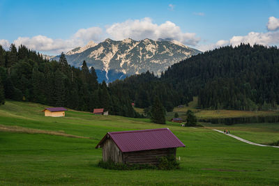 Scenic view of field and mountains against sky