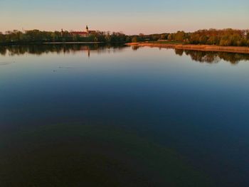 Scenic view of lake against sky at sunset