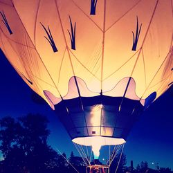 Low angle view of illuminated lanterns against clear sky at night