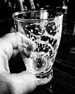 Close-up of cropped hand holding beer glass