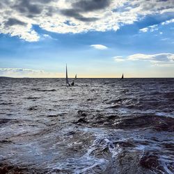 Man sailing in sea against sky