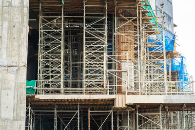 Building under construction with scaffoldings.