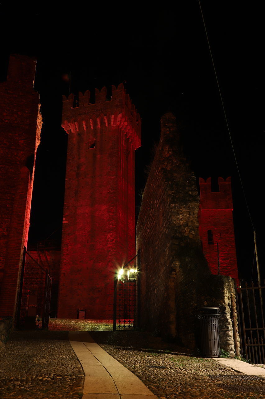 LOW ANGLE VIEW OF ILLUMINATED RED BUILDINGS AT NIGHT