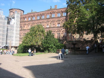 People in town square against sky