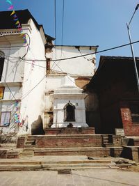 Low angle view of statue in city against sky