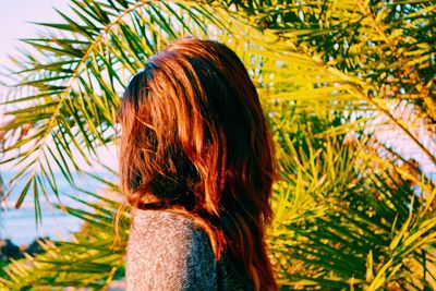 Woman against palm tree