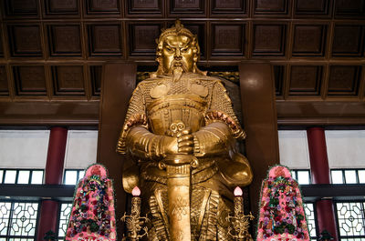 Low angle view of statue against building