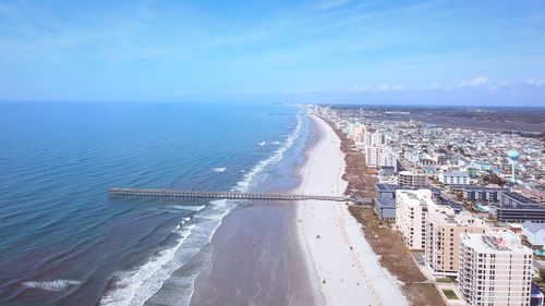 High angle view of sea and cityscape against sky