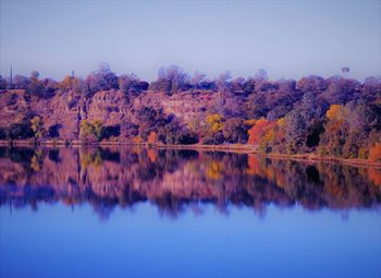 Reflection of trees in lake against sky during autumn