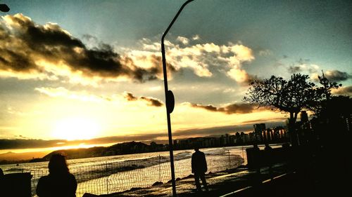 Silhouette of people at sunset