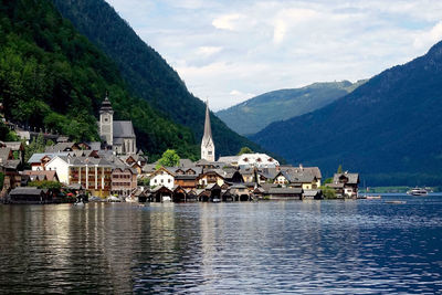 Scenic view of river and mountains against cloudy sky