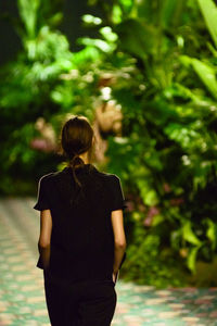Rear view of woman walking in park