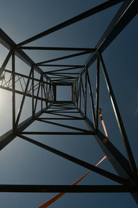 Low angle view of steel structure against sky with white clouds , steel truss in black colour 