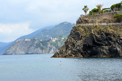 Scenic view of sea and mountains against sky